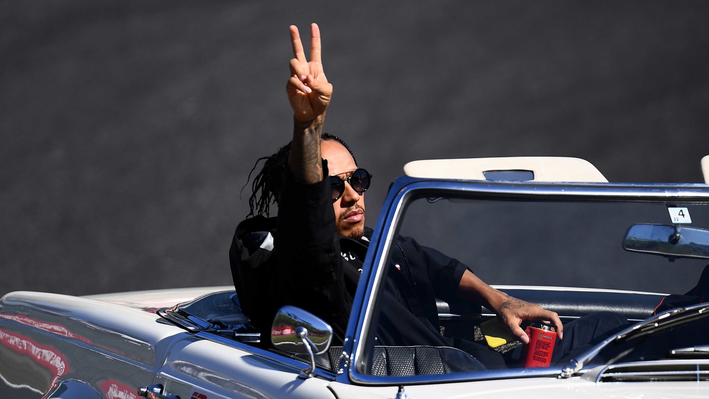 SUZUKA, JAPAN - OCTOBER 13: Lewis Hamilton of Great Britain and Mercedes GP waves to the crowd on the drivers parade before the F1 Grand Prix of Japan at Suzuka Circuit on October 13, 2019 in Suzuka, Japan. (Photo by Clive Mason/Getty Images)
