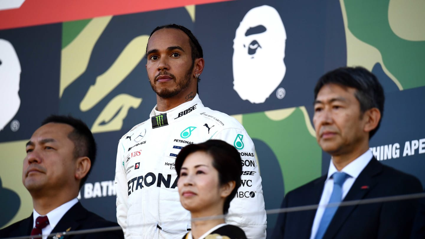 SUZUKA, JAPAN - OCTOBER 13: Third placed Lewis Hamilton of Great Britain and Mercedes GP looks on, on the podium during the F1 Grand Prix of Japan at Suzuka Circuit on October 13, 2019 in Suzuka, Japan. (Photo by Clive Mason/Getty Images)