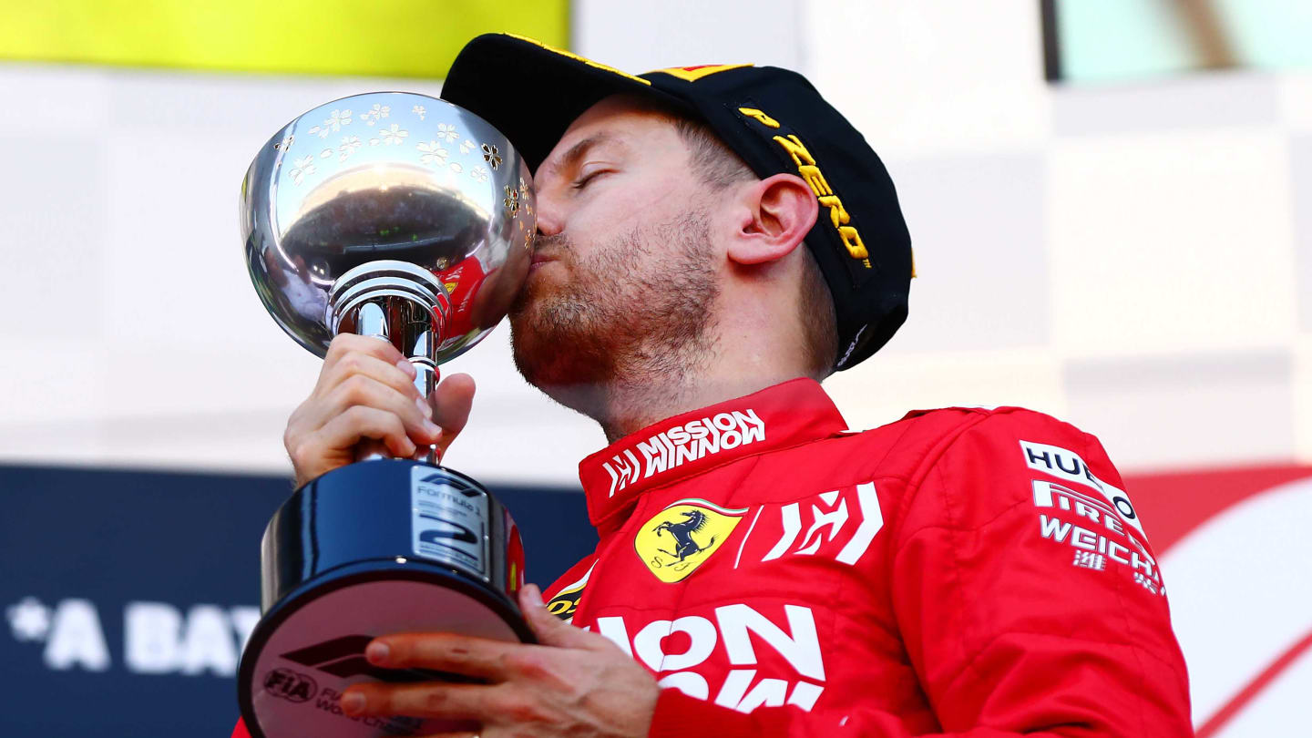 SUZUKA, JAPAN - OCTOBER 13: Second placed Sebastian Vettel of Germany and Ferrari celebrates on the