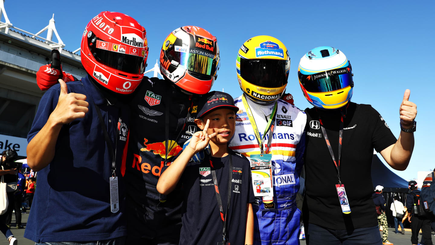 SUZUKA, JAPAN - OCTOBER 13: Ferrari, Red Bull Racing, Williams and McLaren fans show their support