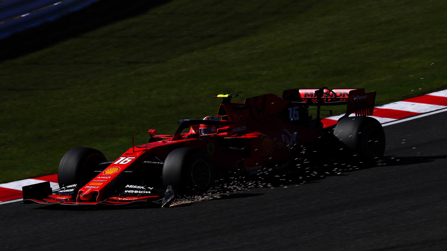 SUZUKA, JAPAN - OCTOBER 13: Sparks fly from the broken front wing of Charles Leclerc of Monaco