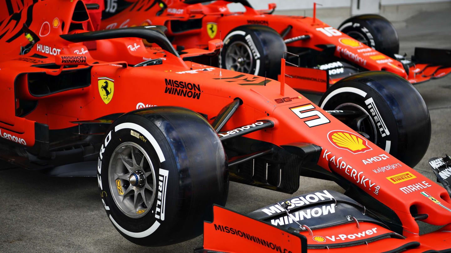 SUZUKA, JAPAN - OCTOBER 10: The cars of Sebastian Vettel of Germany and Ferrari and Charles Leclerc