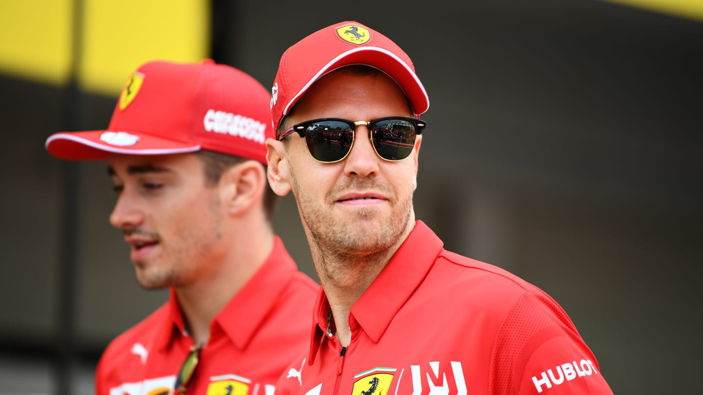 SUZUKA, JAPAN - OCTOBER 10: Sebastian Vettel of Germany and Ferrari and Charles Leclerc of Monaco