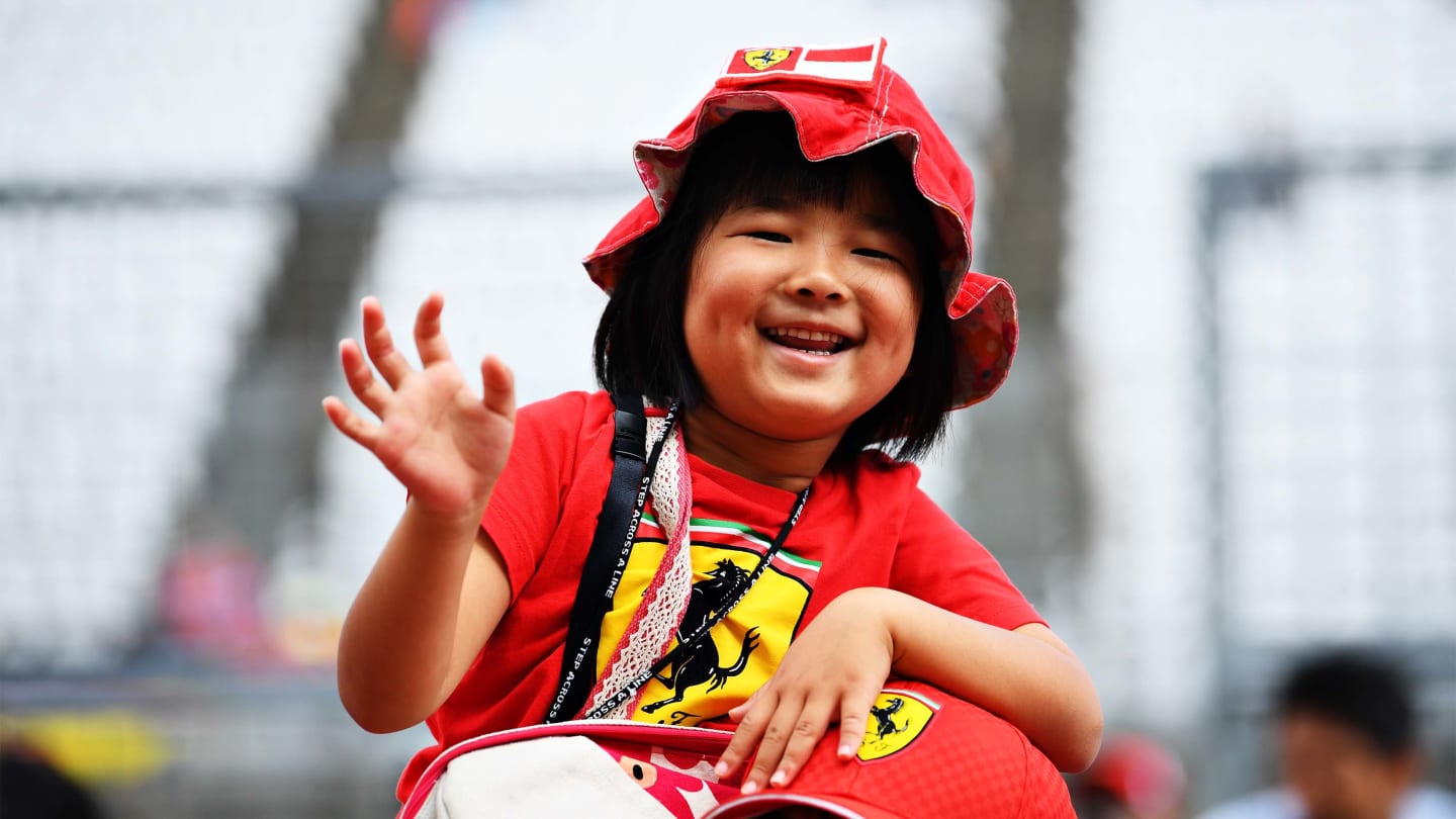 SUZUKA, JAPAN - OCTOBER 10: Young Ferrari fans get excited in the Pitlane during previews ahead of the F1 Grand Prix of Japan at Suzuka Circuit on October 10, 2019 in Suzuka, Japan. (Photo by Clive Mason/Getty Images)