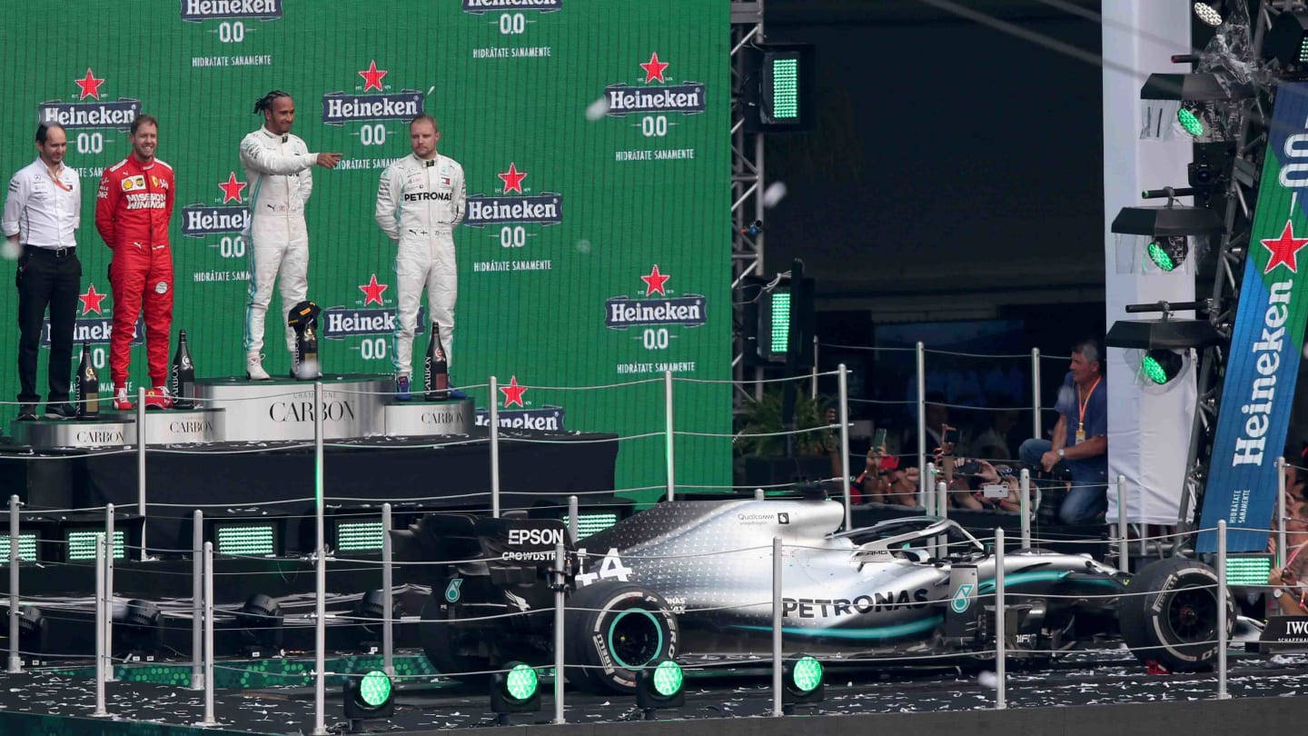 MEXICO CITY, MEXICO - OCTOBER 27: A general view as race winner Lewis Hamilton of Great Britain and Mercedes GP, second placed Sebastian Vettel of Germany and Ferrari and third placed Valtteri Bottas of Finland and Mercedes GP celebrate on the podium during the F1 Grand Prix of Mexico at Autodromo Hermanos Rodriguez on October 27, 2019 in Mexico City, Mexico. (Photo by Charles Coates/Getty Images)