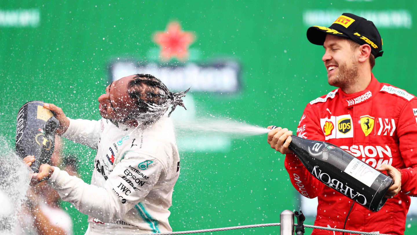 MEXICO CITY, MEXICO - OCTOBER 27: Race winner Lewis Hamilton of Great Britain and Mercedes GP and second placed Sebastian Vettel of Germany and Ferrari celebrate on the podium during the F1 Grand Prix of Mexico at Autodromo Hermanos Rodriguez on October 27, 2019 in Mexico City, Mexico. (Photo by Mark Thompson/Getty Images)