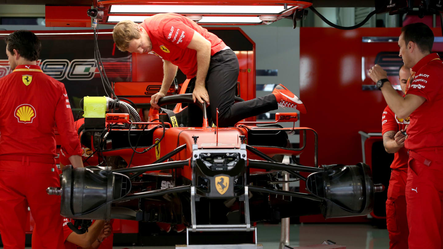SOCHI, RUSSIA - SEPTEMBER 26: Sebastian Vettel of Germany and Ferrari climbs into his car in the
