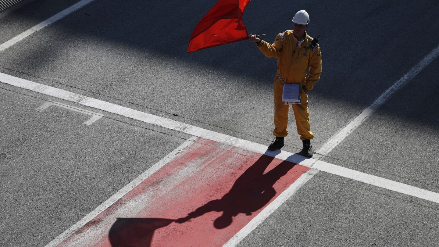 CIRCUIT DE BARCELONA-CATALUNYA, SPAIN - FEBRUARY 26: Marshal waves the red flag during the Barcelona February testing II at Circuit de Barcelona-Catalunya on February 26, 2019 in Circuit de Barcelona-Catalunya, Spain. (Photo by Zak Mauger / LAT Images)