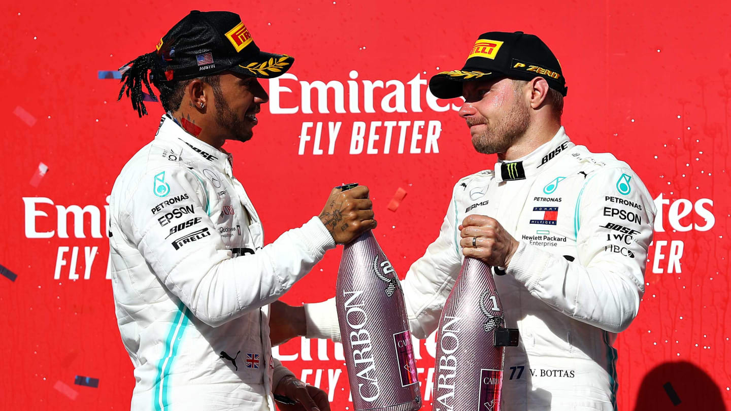 AUSTIN, TEXAS - NOVEMBER 03: 2019 Formula One World Drivers Champion Lewis Hamilton of Great Britain and Mercedes GP and race winner Valtteri Bottas of Finland and Mercedes GP celebrate on the podium during the F1 Grand Prix of USA at Circuit of The Americas on November 03, 2019 in Austin, Texas. (Photo by Mark Thompson/Getty Images)