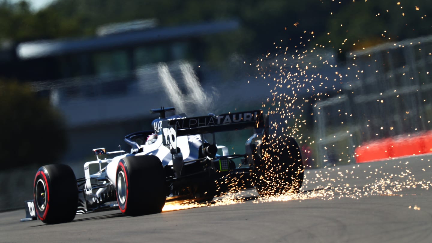 NORTHAMPTON, ENGLAND - AUGUST 07: Sparks fly behind Daniil Kvyat of Russia driving the (26)