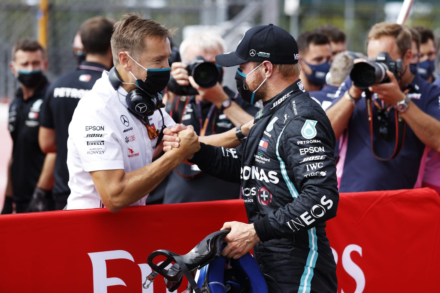 NORTHAMPTON, ENGLAND - AUGUST 08: Pole position qualifier Valtteri Bottas of Finland and Mercedes GP celebrates with a team member in parc ferme during qualifying for the F1 70th Anniversary Grand Prix at Silverstone on August 08, 2020 in Northampton, England. (Photo by Andrew Boyers/Pool via Getty Images)