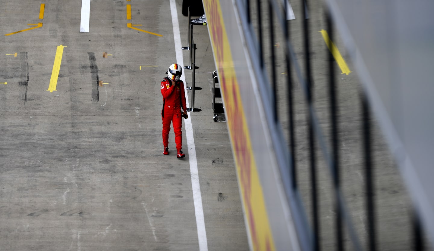 NORTHAMPTON, ENGLAND - AUGUST 08: Sebastian Vettel of Germany and Ferrari walks into the garage during qualifying for the F1 70th Anniversary Grand Prix at Silverstone on August 08, 2020 in Northampton, England. (Photo by Rudy Carezzevoli/Getty Images)