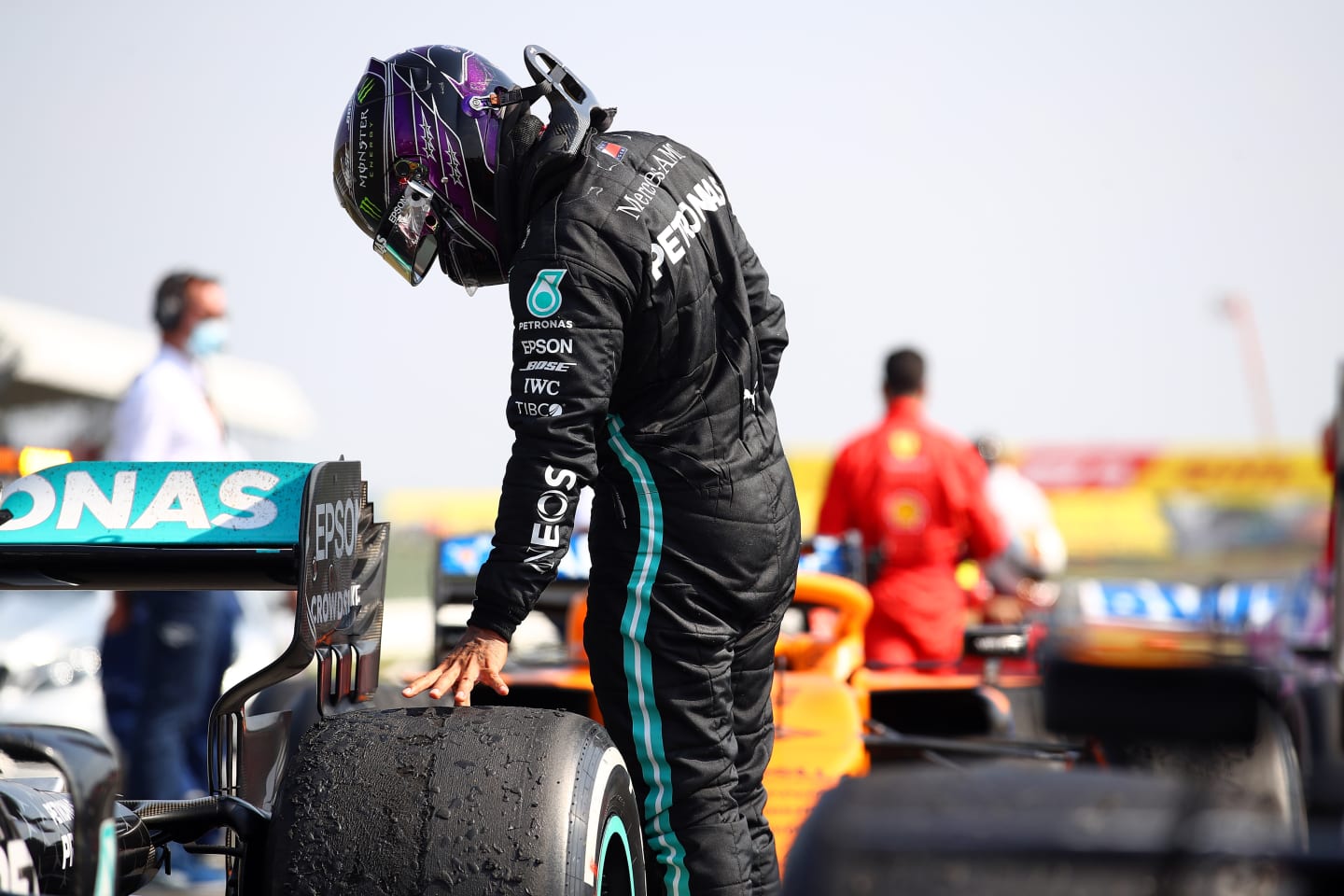 NORTHAMPTON, ENGLAND - AUGUST 09: Second placed Lewis Hamilton of Great Britain and Mercedes GP checks the wear on his tyres in parc ferme during the F1 70th Anniversary Grand Prix at Silverstone on August 09, 2020 in Northampton, England. (Photo by Bryn Lennon/Getty Images)