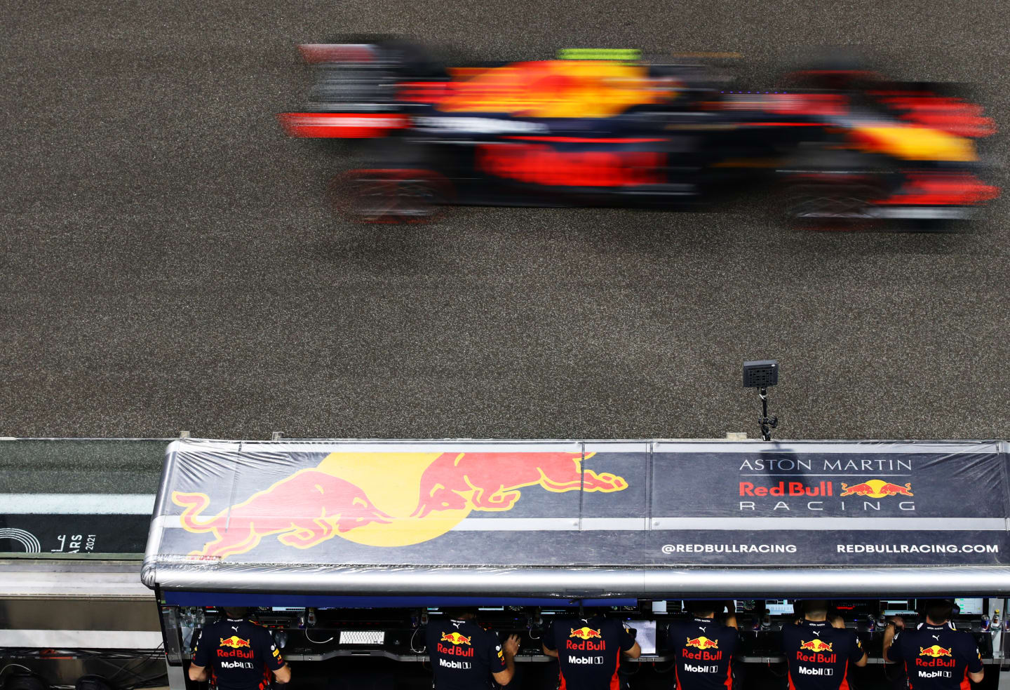 ABU DHABI, UNITED ARAB EMIRATES - DECEMBER 12: Alexander Albon of Thailand driving the (23) Aston Martin Red Bull Racing RB16 passes the Red Bull Racing pitwall during qualifying ahead of the F1 Grand Prix of Abu Dhabi at Yas Marina Circuit on December 12, 2020 in Abu Dhabi, United Arab Emirates. (Photo by Mark Thompson/Getty Images)
