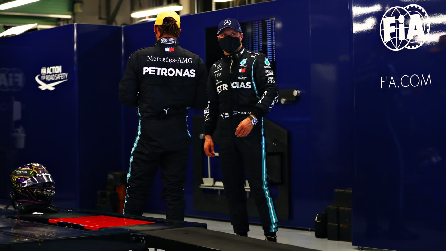 ABU DHABI, UNITED ARAB EMIRATES - DECEMBER 12: Second place qualifier Valtteri Bottas of Finland and Mercedes GP and third place qualifier Lewis Hamilton of Great Britain and Mercedes GP talk as they are weighed in parc ferme during qualifying ahead of the F1 Grand Prix of Abu Dhabi at Yas Marina Circuit on December 12, 2020 in Abu Dhabi, United Arab Emirates. (Photo by Dan Istitene - Formula 1/Formula 1 via Getty Images)