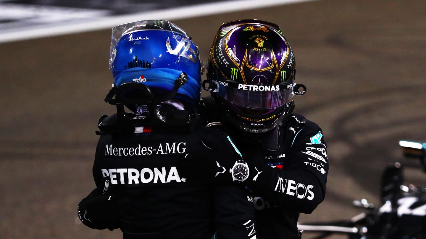 ABU DHABI, UNITED ARAB EMIRATES - DECEMBER 13: Second placed Valtteri Bottas of Finland and Mercedes GP and third placed Lewis Hamilton of Great Britain and Mercedes GP hug in parc ferme during the F1 Grand Prix of Abu Dhabi at Yas Marina Circuit on December 13, 2020 in Abu Dhabi, United Arab Emirates. (Photo by Dan Istitene - Formula 1/Formula 1 via Getty Images)