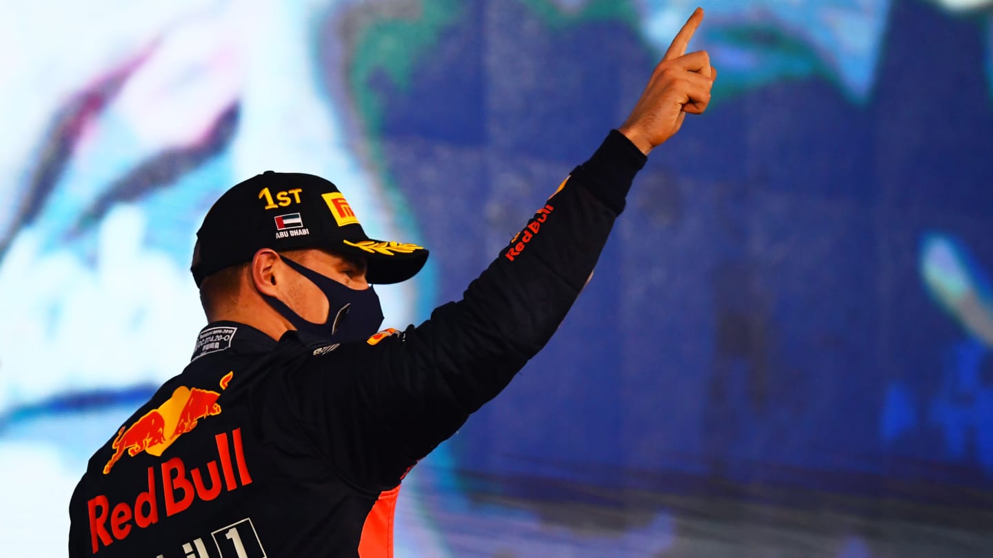 ABU DHABI, UNITED ARAB EMIRATES - DECEMBER 13: Race winner Max Verstappen of Netherlands and Red Bull Racing celebrates on the podium during the F1 Grand Prix of Abu Dhabi at Yas Marina Circuit on December 13, 2020 in Abu Dhabi, United Arab Emirates. (Photo by Clive Mason - Formula 1/Formula 1 via Getty Images)