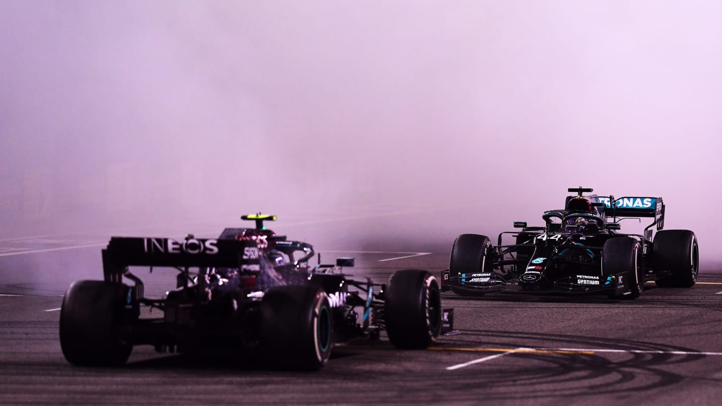 ABU DHABI, UNITED ARAB EMIRATES - DECEMBER 13: Second placed Valtteri Bottas of Finland and Mercedes GP and third placed Lewis Hamilton of Great Britain and Mercedes GP perform donuts following the F1 Grand Prix of Abu Dhabi at Yas Marina Circuit on December 13, 2020 in Abu Dhabi, United Arab Emirates. (Photo by Mario Renzi - Formula 1/Formula 1 via Getty Images)