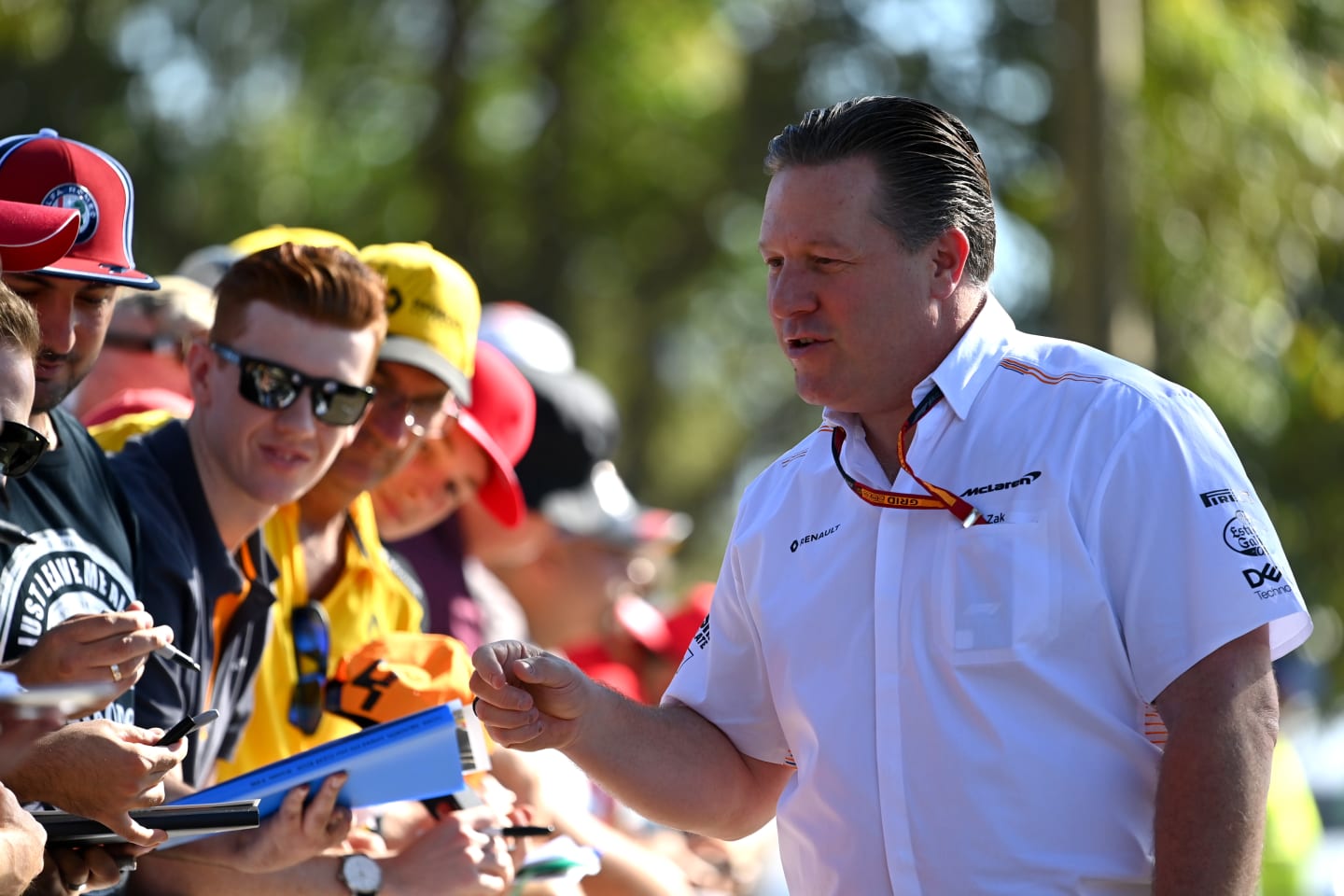 MELBOURNE, AUSTRALIA - MARCH 12: McLaren Chief Executive Officer Zak Brown sings autographs as he