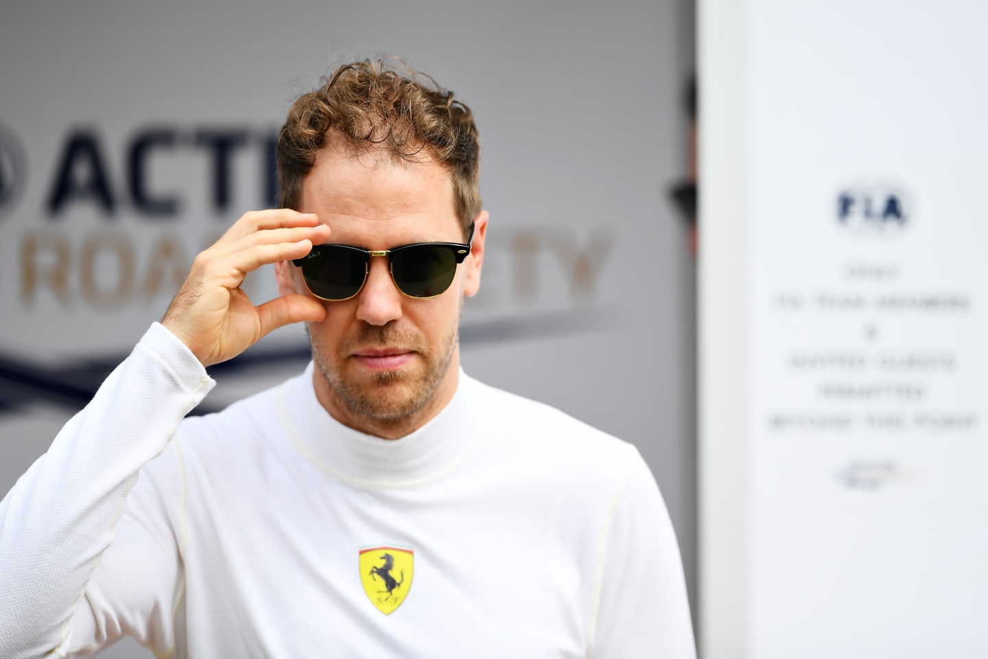 MELBOURNE, AUSTRALIA - MARCH 12: Sebastian Vettel of Germany and Ferrari walks in the Paddock