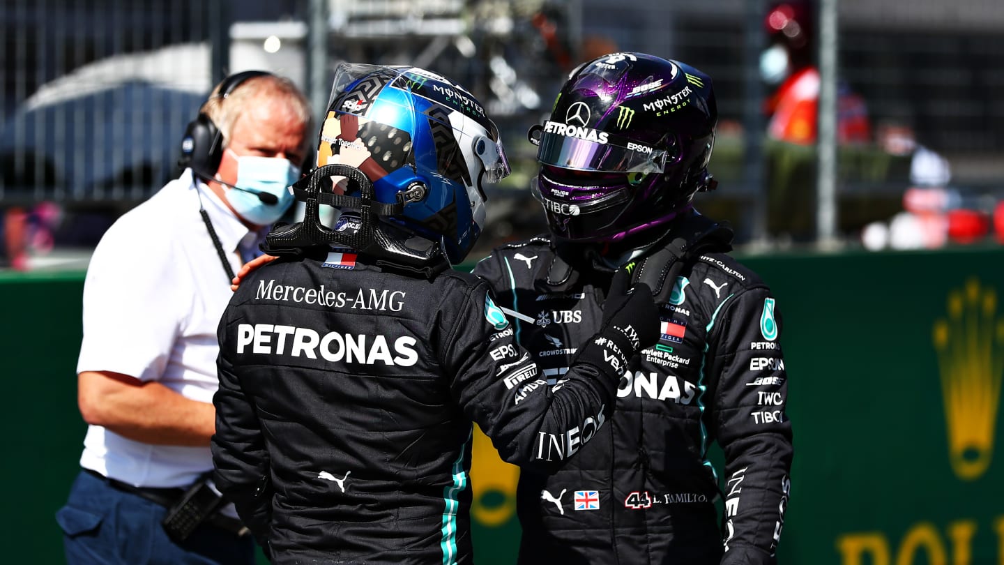 SPIELBERG, AUSTRIA - JULY 04: Pole position qualifier Valtteri Bottas of Finland and Mercedes GP and second place qualifier Lewis Hamilton of Great Britain and Mercedes GP shake hands in parc ferin parc fermeduring qualifying for the Formula One Grand Prix of Austria at Red Bull Ring on July 04, 2020 in Spielberg, Austria. (Photo by Dan Istitene - Formula 1/Formula 1 via Getty Images)