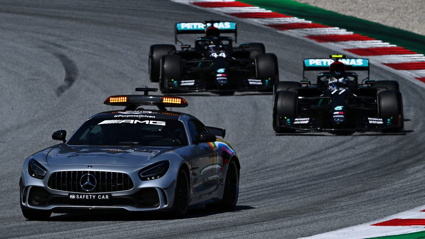 SPIELBERG, AUSTRIA - JULY 05: The safety car leads Valtteri Bottas of Finland driving the (77)