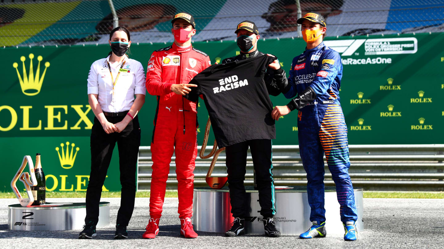 SPIELBERG, AUSTRIA - JULY 05: Race winner Valtteri Bottas of Finland and Mercedes GP, second placed Charles Leclerc of Monaco and Ferrari and third placed Lando Norris of Great Britain and McLaren F1 pose with an End Racism shirt during the Formula One Grand Prix of Austria at Red Bull Ring on July 05, 2020 in Spielberg, Austria. (Photo by Dan Istitene - Formula 1/Formula 1 via Getty Images)