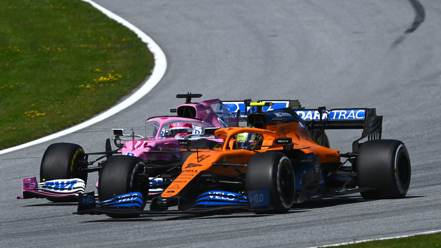 SPIELBERG, AUSTRIA - JULY 05: Lando Norris of Great Britain driving the (4) McLaren F1 Team MCL35 Renault and Sergio Perez of Mexico driving the (11) Racing Point RP20 Mercedes battle for position during the Formula One Grand Prix of Austria at Red Bull Ring on July 05, 2020 in Spielberg, Austria. (Photo by Clive Mason - Formula 1/Formula 1 via Getty Images)
