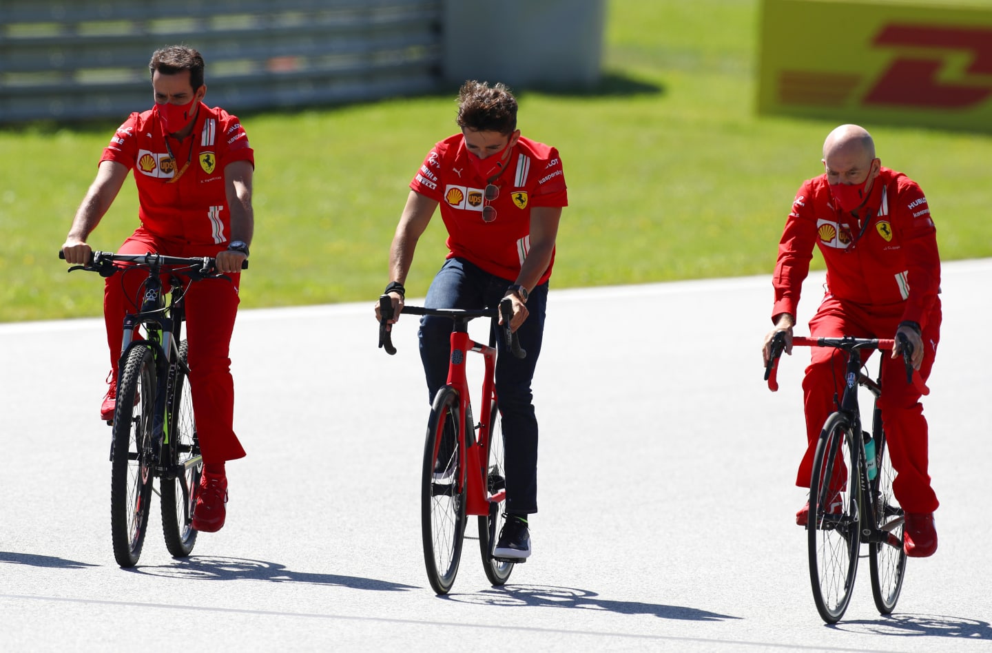 SPIELBERG, AUSTRIA - JULY 02: Charles Leclerc of Monaco and Ferrari rides a bike as he inspects the