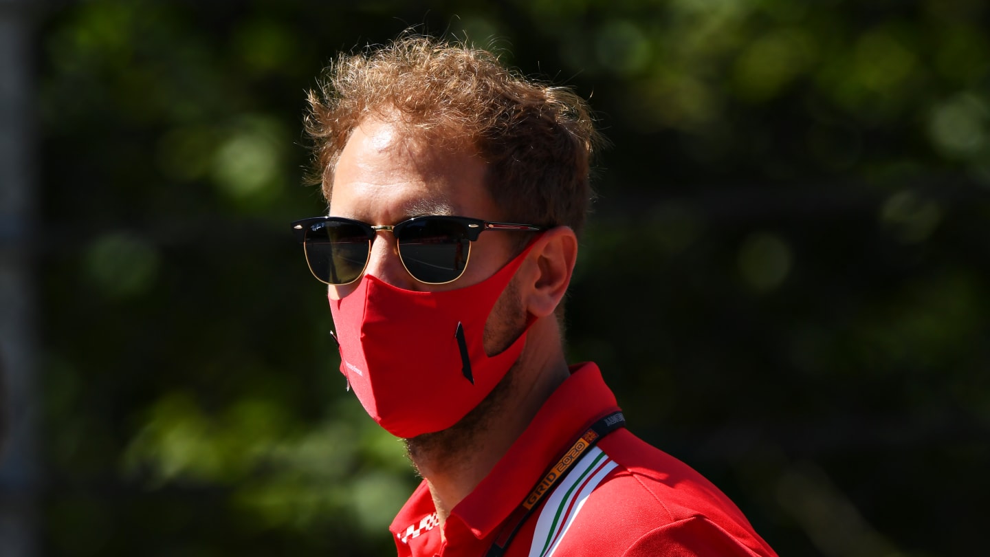 SPIELBERG, AUSTRIA - JULY 02: Sebastian Vettel of Germany and Ferrari walks the track with his team