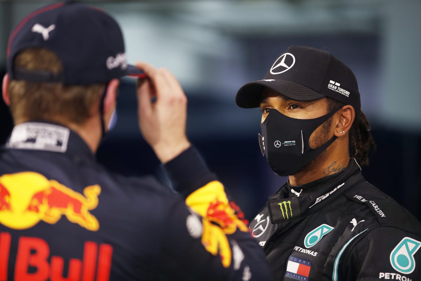 BAHRAIN, BAHRAIN - NOVEMBER 28: Pole position qualifier Lewis Hamilton of Great Britain and Mercedes GP speaks with third placed qualifier Max Verstappen of Netherlands and Red Bull Racing in parc ferme during qualifying ahead of the F1 Grand Prix of Bahrain at Bahrain International Circuit on November 28, 2020 in Bahrain, Bahrain. (Photo by Hamad Mohammed - Pool/Getty Images)