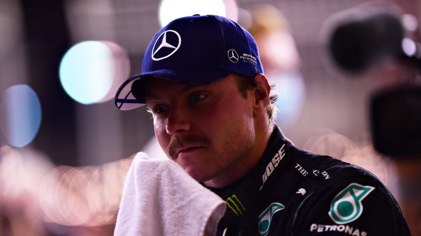 BAHRAIN, BAHRAIN - NOVEMBER 28: Second place qualifier Valtteri Bottas of Finland and Mercedes GP wipes his face in parc ferme during qualifying ahead of the F1 Grand Prix of Bahrain at Bahrain International Circuit on November 28, 2020 in Bahrain, Bahrain. (Photo by Mario Renzi - Formula 1/Formula 1 via Getty Images)
