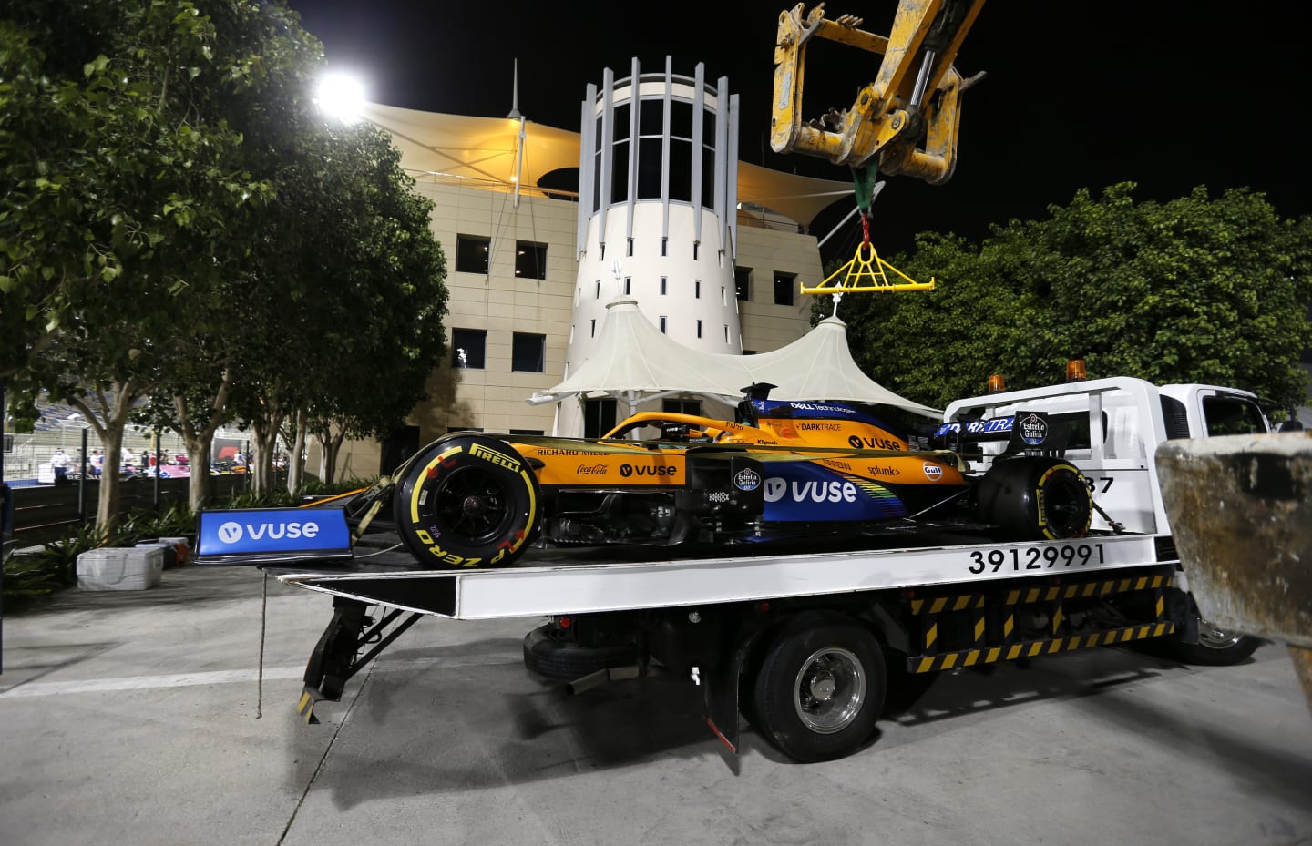 BAHRAIN, BAHRAIN - NOVEMBER 28: The car of Carlos Sainz of Spain and McLaren F1 is seen on a pickup truck after retiring during qualifying ahead of the F1 Grand Prix of Bahrain at Bahrain International Circuit on November 28, 2020 in Bahrain, Bahrain. (Photo by Hamad Mohammed - Pool/Getty Images)