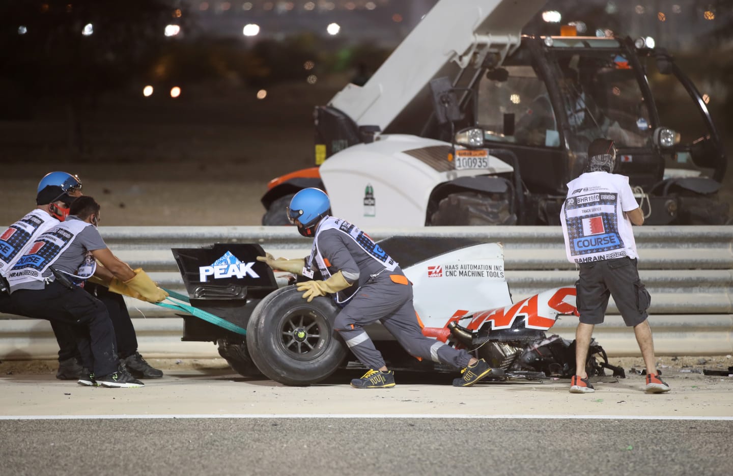 BAHRAIN, BAHRAIN - NOVEMBER 29: Track marshals clear the debris following the crash of Romain