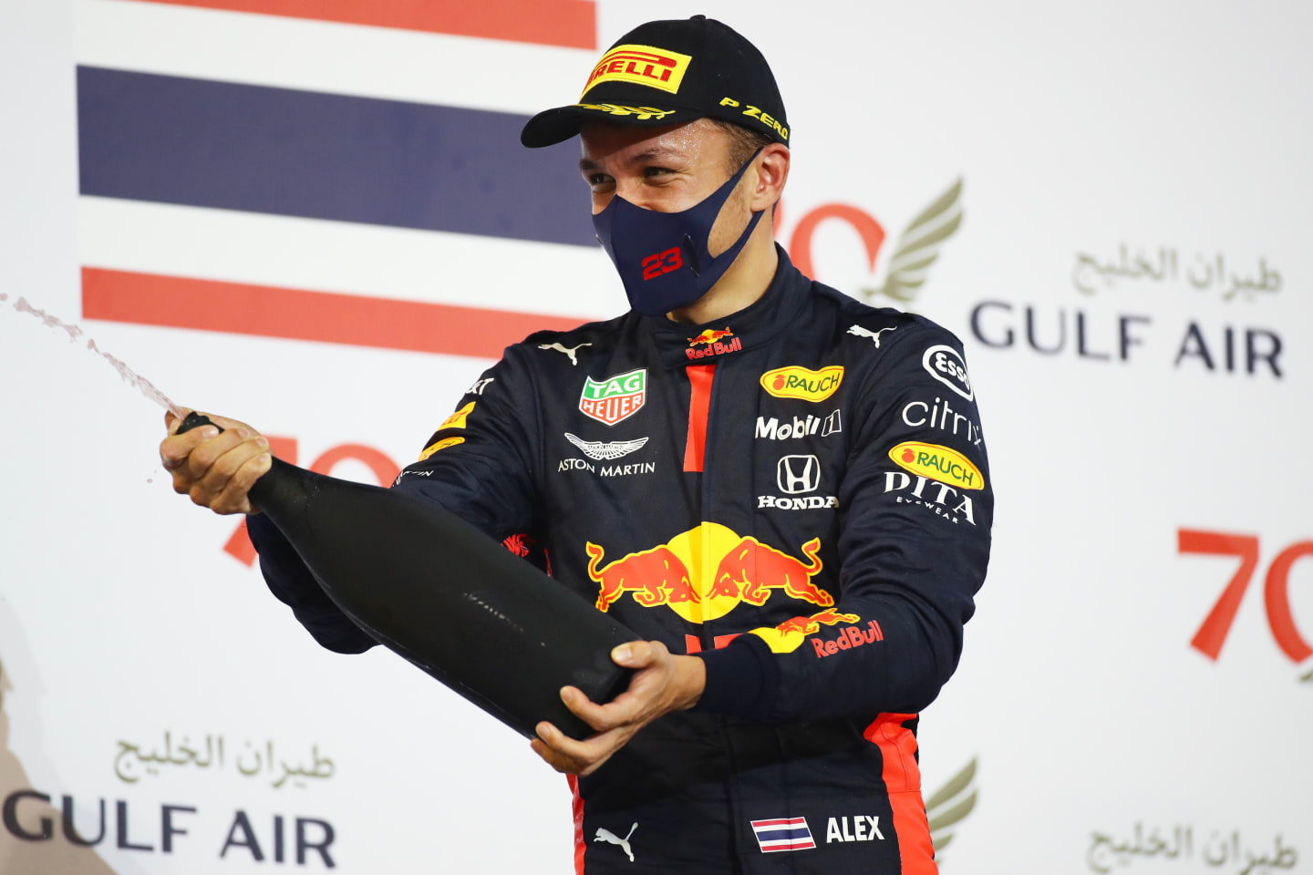 BAHRAIN, BAHRAIN - NOVEMBER 29: Third placed Alexander Albon of Thailand and Red Bull Racing celebrates on the podium during the F1 Grand Prix of Bahrain at Bahrain International Circuit on November 29, 2020 in Bahrain, Bahrain. (Photo by Bryn Lennon/Getty Images)