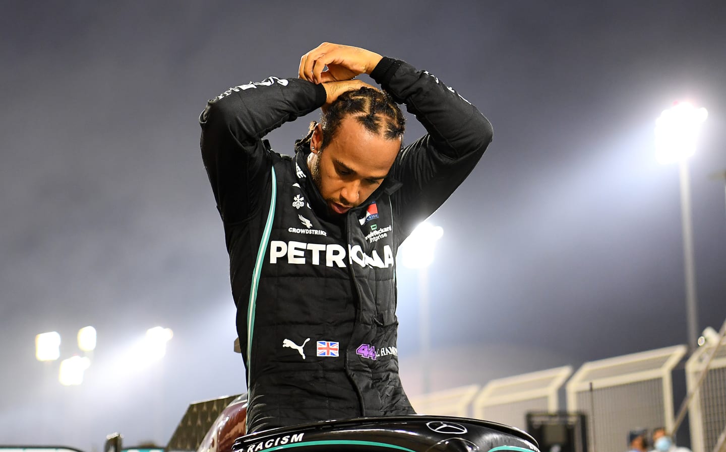 BAHRAIN, BAHRAIN - NOVEMBER 29: Race winner Lewis Hamilton of Great Britain and Mercedes GP climbs