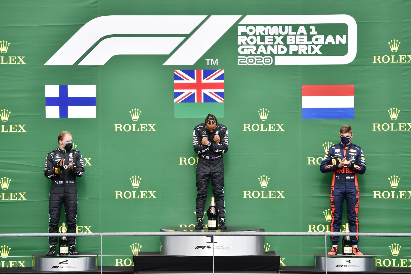 SPA, BELGIUM - AUGUST 30: Race winner Lewis Hamilton of Great Britain and Mercedes GP, second placed Valtteri Bottas of Finland and Mercedes GP and third placed Max Verstappen of Netherlands and Red Bull Racing stand on the podium during the F1 Grand Prix of Belgium at Circuit de Spa-Francorchamps on August 30, 2020 in Spa, Belgium. (Photo by John Thuys/Pool via Getty Images)