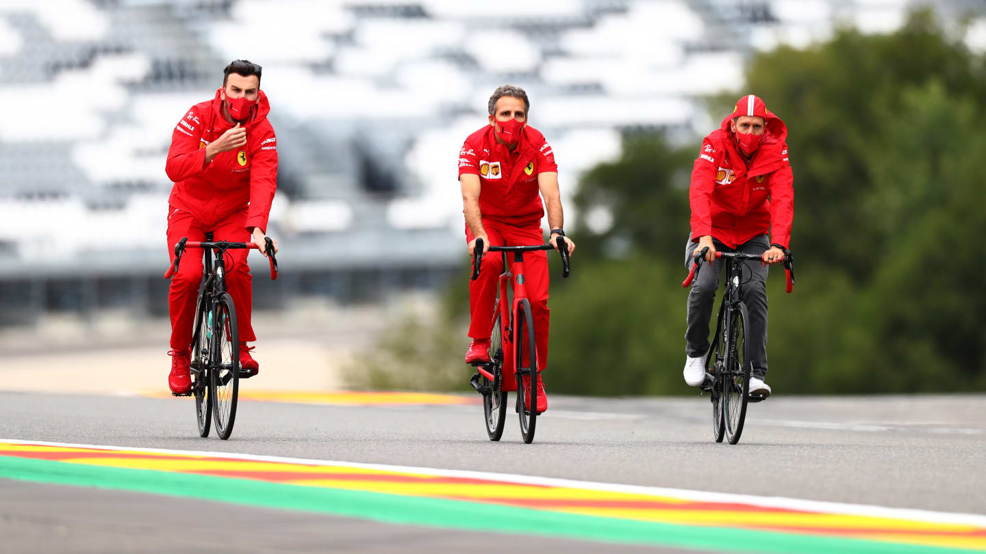 SPA, BELGIUM - AUGUST 27: Sebastian Vettel of Germany and Ferrari cycles the track with team