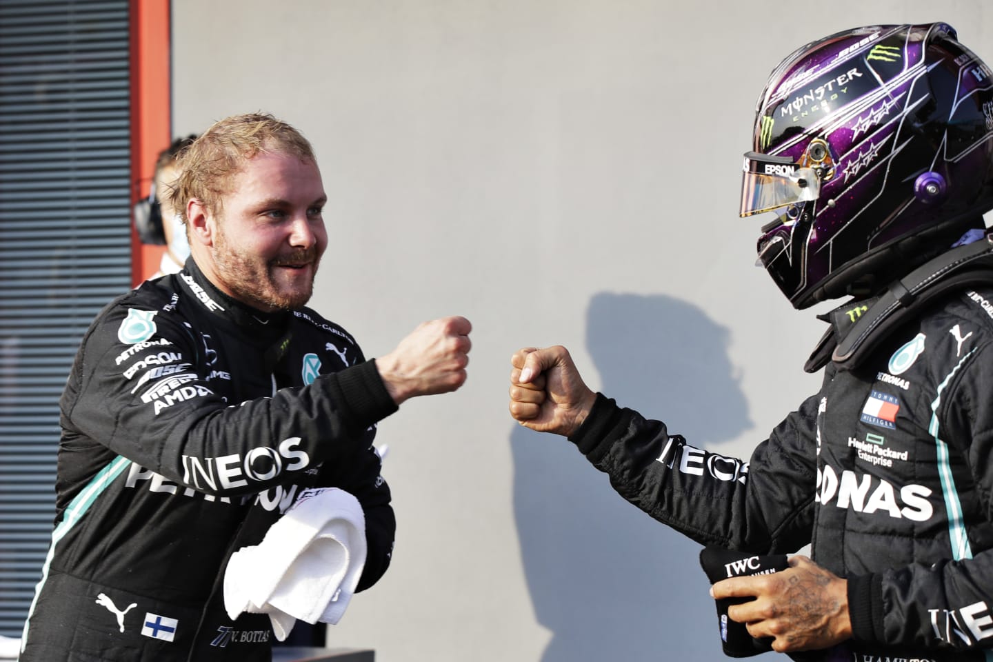 IMOLA, ITALY - OCTOBER 31: Pole position qualifier Valtteri Bottas of Finland and Mercedes GP bumps fists with second place qualifier Lewis Hamilton of Great Britain and Mercedes GP in parc ferme in parc ferme during qualifying ahead of the F1 Grand Prix of Emilia Romagna at Autodromo Enzo e Dino Ferrari on October 31, 2020 in Imola, Italy. (Photo by Luca Bruno - Pool/Getty Images)