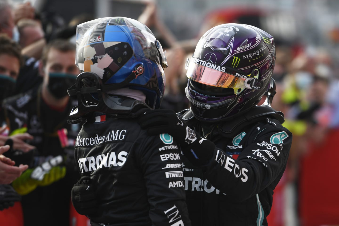 IMOLA, ITALY - NOVEMBER 01: Race winner Lewis Hamilton of Great Britain and Mercedes GP (R) embraces teammate and second placed Valtteri Bottas of Finland and Mercedes GP (L) in parc ferme during the F1 Grand Prix of Emilia Romagna at Autodromo Enzo e Dino Ferrari on November 01, 2020 in Imola, Italy. (Photo by Rudy Carezzevoli/Getty Images)