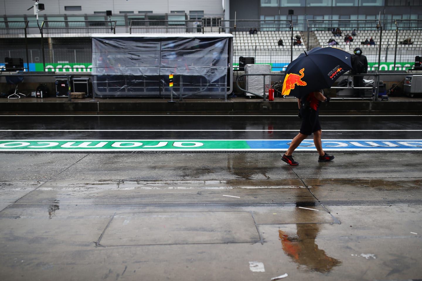 NUERBURG, GERMANY - OCTOBER 09: A Red Bull Racing team member walks in the Pitlane during practice