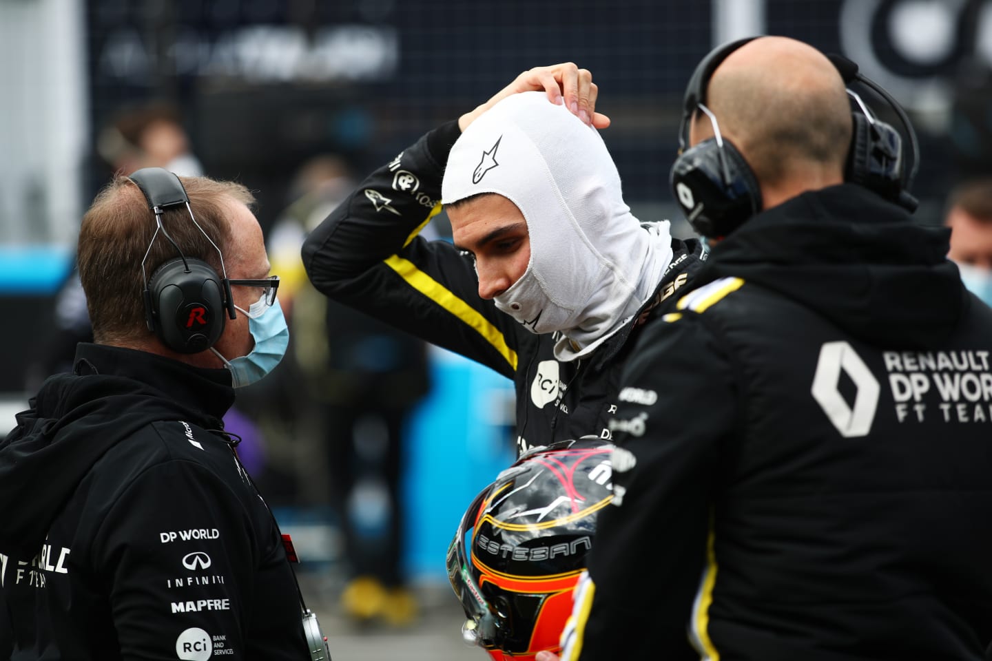 NUERBURG, GERMANY - OCTOBER 11: Esteban Ocon of France and Renault Sport F1 talks to a team member