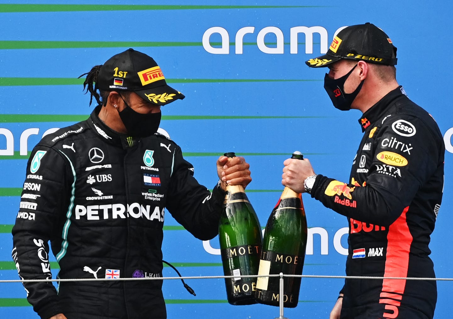 NUERBURG, GERMANY - OCTOBER 11: Race winner Lewis Hamilton of Great Britain and Mercedes GP and second placed Max Verstappen of Netherlands and Red Bull Racing celebrate on the podium during the F1 Eifel Grand Prix at Nuerburgring on October 11, 2020 in Nuerburg, Germany. (Photo by Ina Fassbender - Pool/Getty Images)