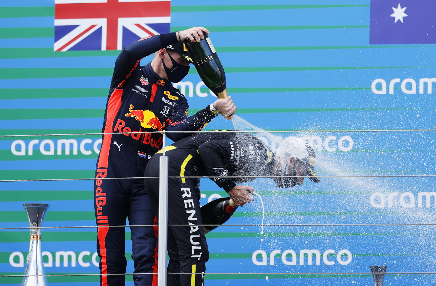NUERBURG, GERMANY - OCTOBER 11: Race winner Lewis Hamilton of Great Britain and Mercedes GP and second placed Max Verstappen of Netherlands and Red Bull Racing celebrate on the podium during the F1 Eifel Grand Prix at Nuerburgring on October 11, 2020 in Nuerburg, Germany. (Photo by Ronald Wittek - Pool/Getty Images)
