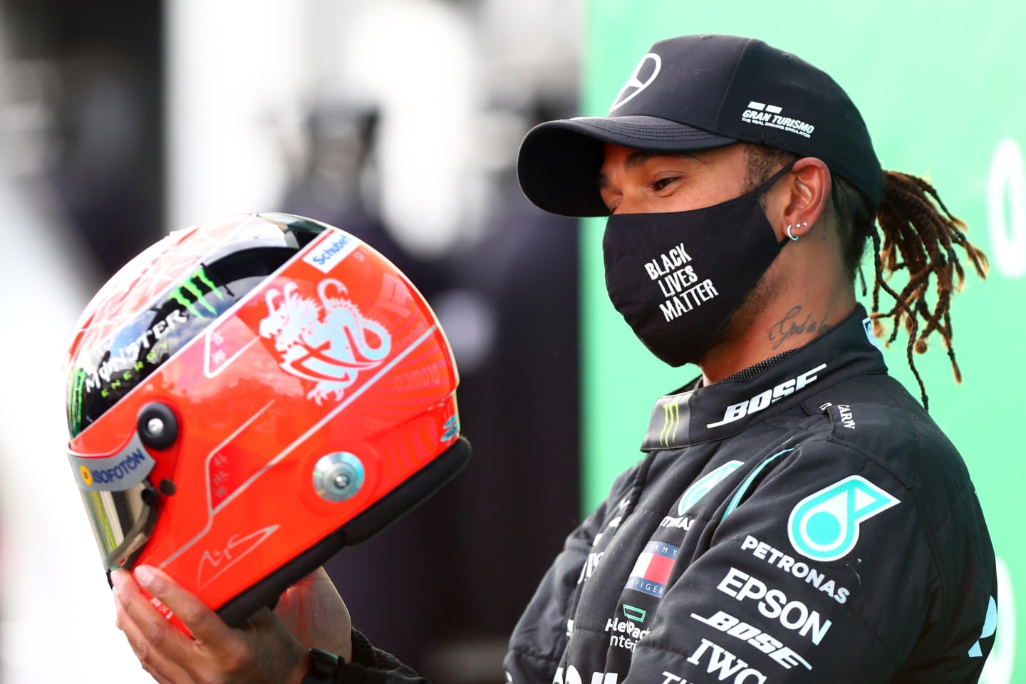 NUERBURG, GERMANY - OCTOBER 11: Race winner Lewis Hamilton of Great Britain and Mercedes GP celebrates after being presented with a helmet of Michael Schumacher for matching his record of 91 race wins during the F1 Eifel Grand Prix at Nuerburgring on October 11, 2020 in Nuerburg, Germany. (Photo by Dan Istitene - Formula 1/Formula 1 via Getty Images)
