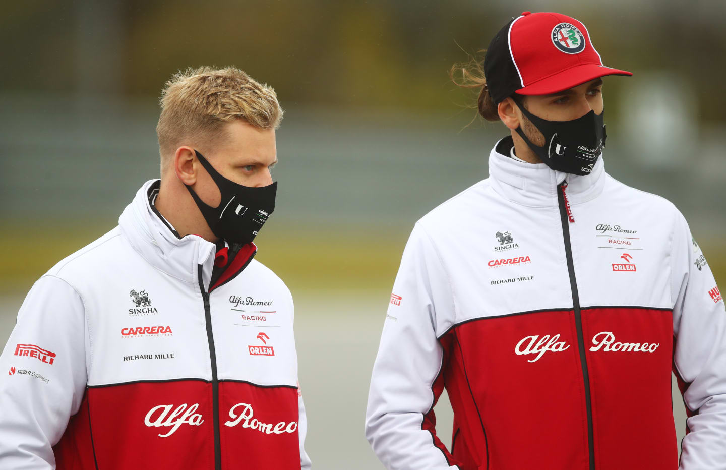 NUERBURG, GERMANY - OCTOBER 08: Mick Schumacher of Germany and Alfa Romeo Racing talks with Antonio Giovinazzi of Italy and Alfa Romeo Racing on a track walk during previews ahead of the F1 Eifel Grand Prix at Nuerburgring on October 08, 2020 in Nuerburg, Germany. (Photo by Bryn Lennon/Getty Images)