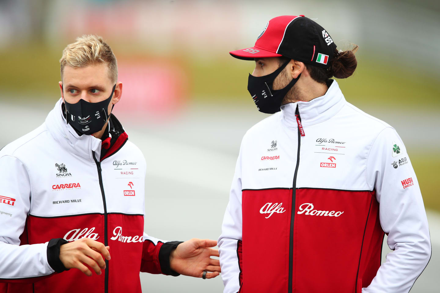 NUERBURG, GERMANY - OCTOBER 08: Mick Schumacher of Germany and Alfa Romeo Racing talks with Antonio