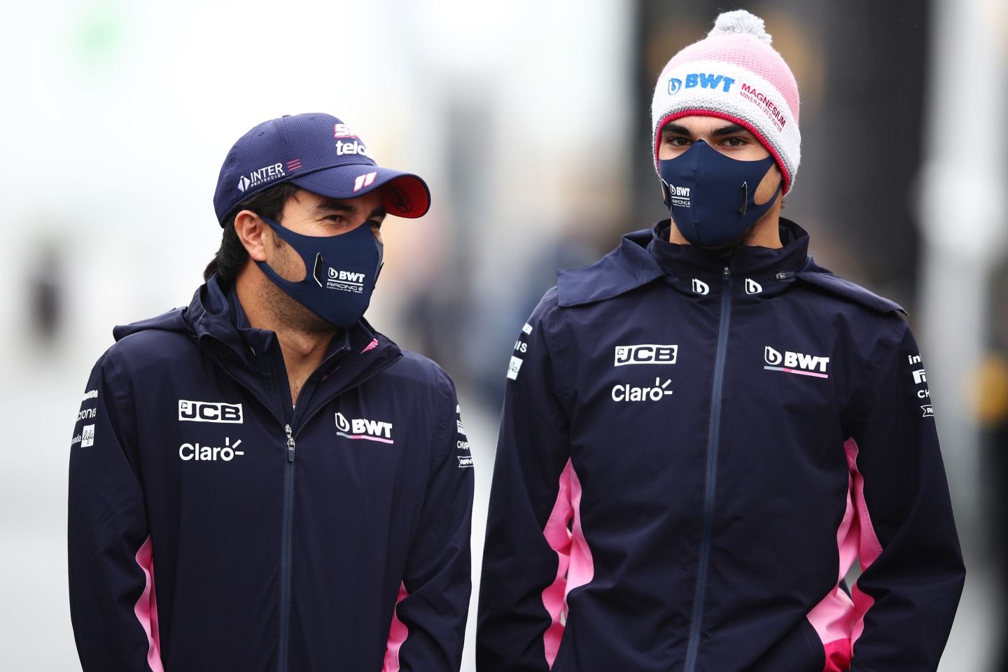 NUERBURG, GERMANY - OCTOBER 08: Sergio Perez of Mexico and Racing Point and Nicholas Latifi of Canada and Williams walk in the Paddock during previews ahead of the F1 Eifel Grand Prix at Nuerburgring on October 08, 2020 in Nuerburg, Germany. (Photo by Mark Thompson/Getty Images)