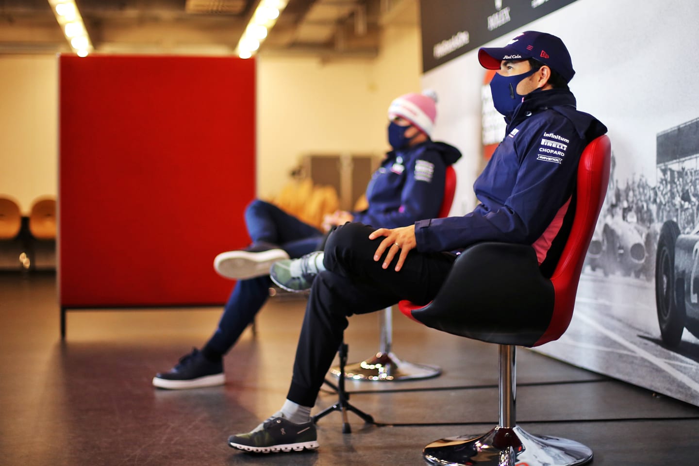 NUERBURG, GERMANY - OCTOBER 08: Lance Stroll of Canada and Racing Point and Sergio Perez of Mexico and Racing Point talk in the Drivers Press Conference during previews ahead of the F1 Eifel Grand Prix at Nuerburgring on October 08, 2020 in Nuerburg, Germany. (Photo by XPB - Pool/Getty Images)