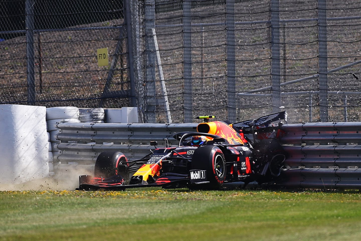 NORTHAMPTON, ENGLAND - JULY 31: Alexander Albon of Thailand driving the (23) Aston Martin Red Bull Racing RB16 crashes into a track barrier during practice for the F1 Grand Prix of Great Britain at Silverstone on July 31, 2020 in Northampton, England. (Photo by Bryn Lennon/Getty Images)